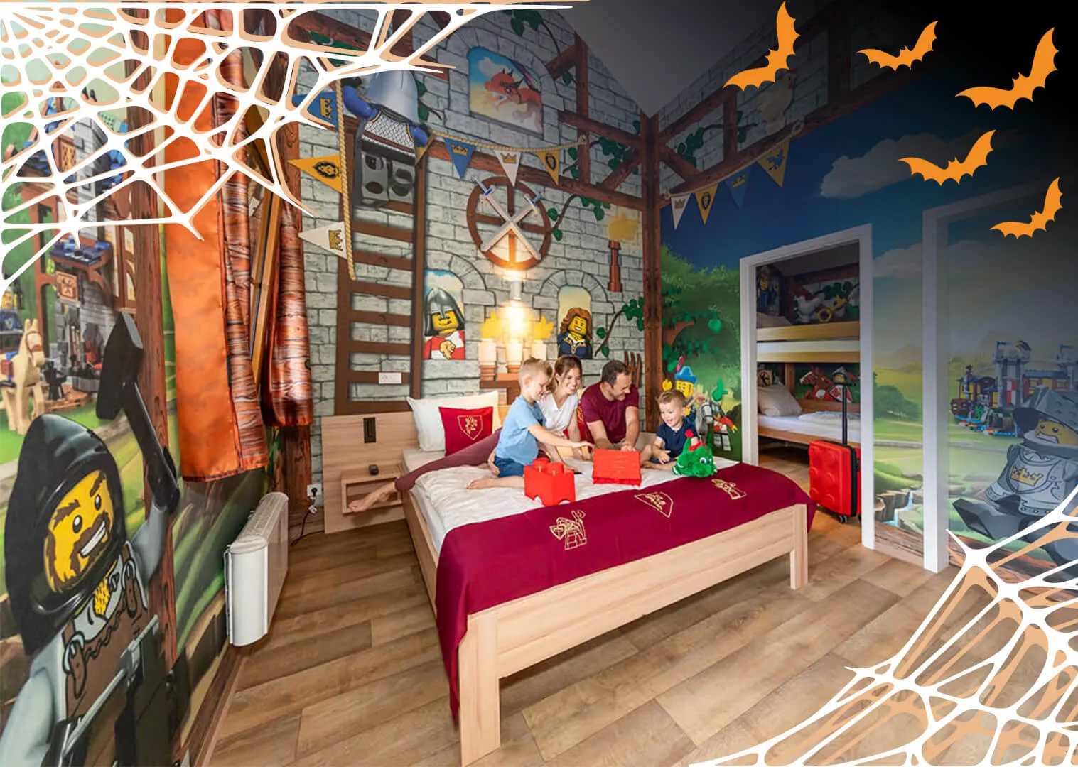 Family with children in a room in the LEGOLAND vacation village on Halloween